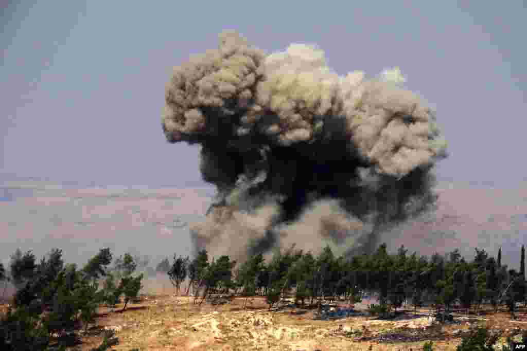 Smoke billows at the site of a reported Russian strike in a forest area west of in Syria's rebel-held northwestern city of Idlib.