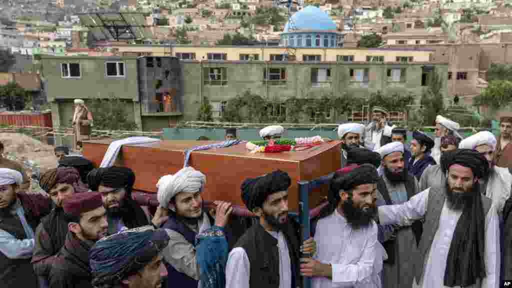 Mourners carry the body of a victim of Wednesday's mosque bombing in Kabul, Afghanistan, that killed at least 10 people and injured 12.