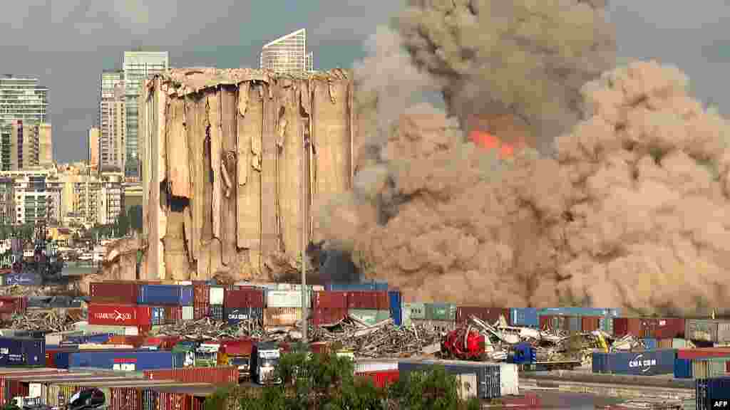 This grab from AFPTV footage shot shows a smoke plume rising after the new collapse of the northern section of the grain silos at the port of Lebanon's capital Beirut, which were previously partly destroyed by the 2020 port explosion.