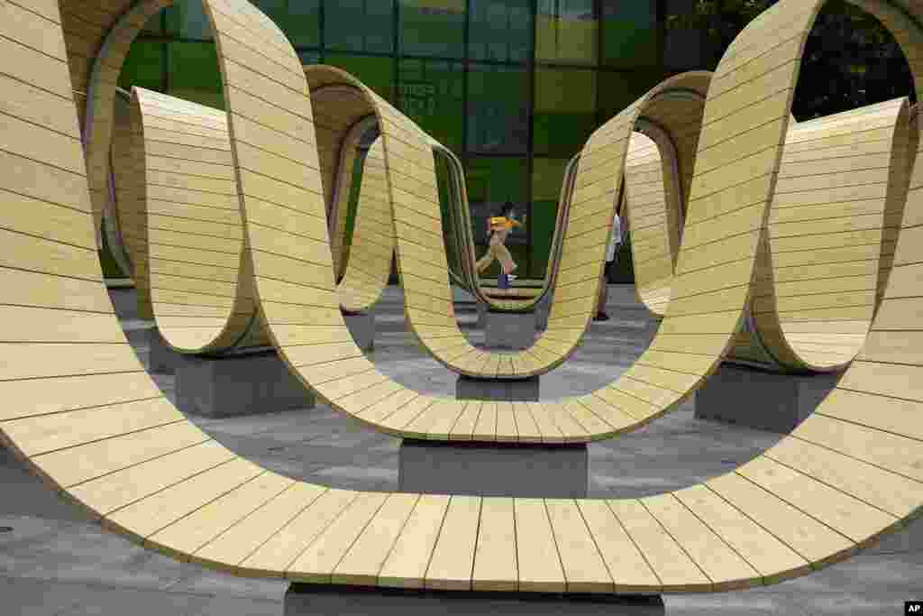 A child wearing a mask runs through an art installation at a mall in Beijing.
