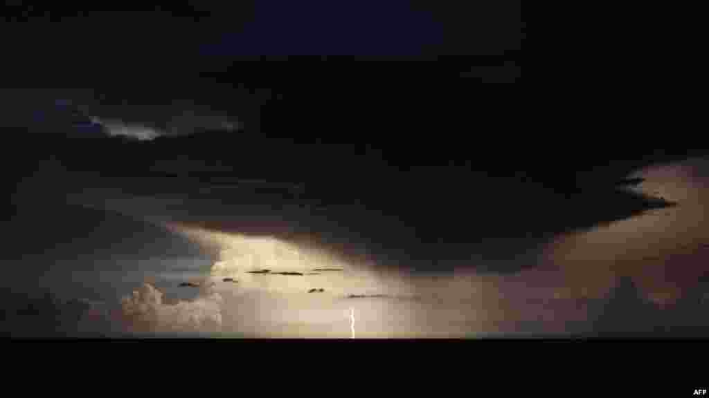 A photograph taken from the French riviera city of Nice, shows lightning flashes in a supercell thunderstorm over the Mediterranean sea on the night of August 18 to 19.