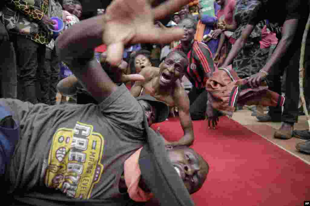 Supporters of presidential candidate Raila Odinga react as he arrives at his campaign headquarters after submitting a petition at the Supreme Court in Nairobi, Kenya. Odinga filed a Supreme Court challenge to last week's election result, asserting that the process was marked by criminal subversion and seeking that the outcome be nullified and a new vote be ordered.