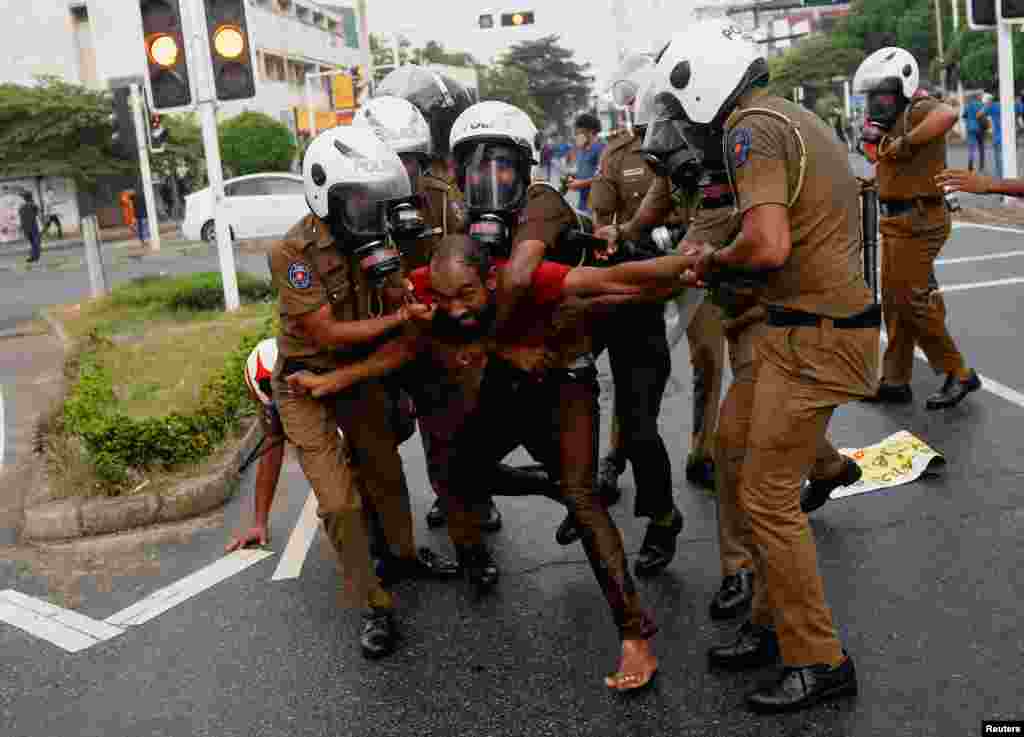 Sri Lankan police officers detain a demonstrator during an anti-government protest by Inter-University Student's Federation, amid the country's economic crisis, in Colombo.
