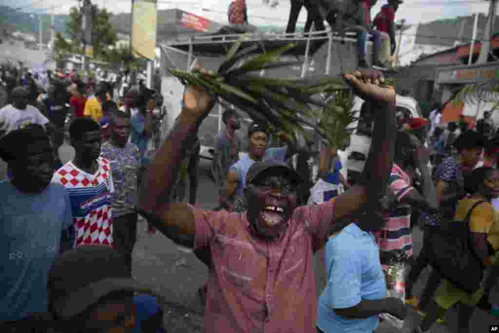 A demonstrator shouts during a protest to demand Haitian Prime Minister Ariel Henry step down and call for better quality of life, in Port-au-Prince, Aug. 22, 2022.