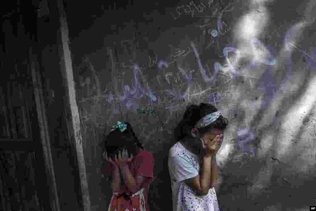 Palestinian girls react during the funeral of 11-year-old Layan al-Shaer in Khan Younis, in the Gaza Strip. Al-Shaer died of her wounds after she was injured in last week's Israeli airstrikes.