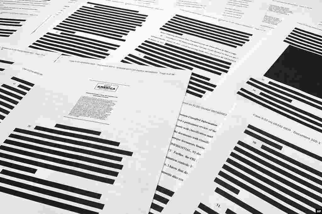 Pages from the affidavit by the FBI in support of obtaining a search warrant for former President Donald Trump's Mar-a-Lago estate are photographed. U.S. Magistrate Judge Bruce Reinhart ordered the Justice Department to make public a redacted version of the affidavit it relied on when federal agents searched Trump's estate to look for classified documents.