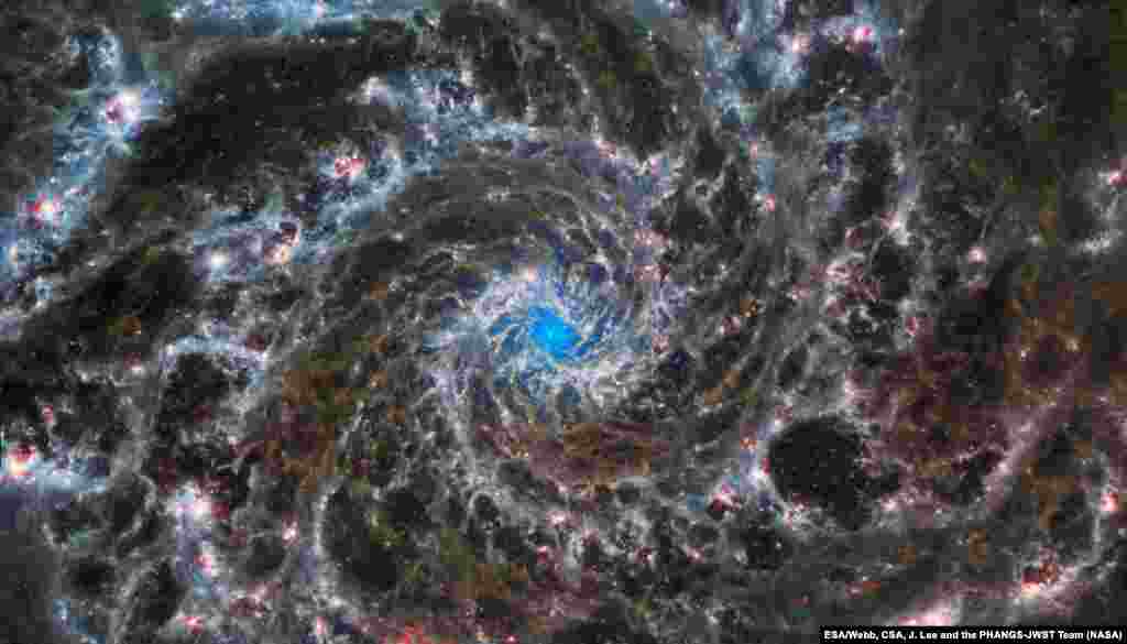 This image shows the heart of M74, otherwise known as the Phantom Galaxy. Webb’s sharp vision has revealed delicate filaments of gas and dust in the grandiose spiral arms which wind outwards from the centrt of this image. 
