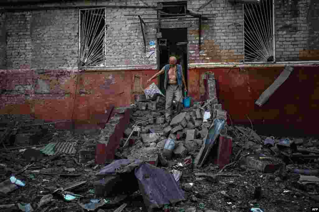 A man leaves his damaged apartment building following a missile strike in Kramatorsk, Donetsk region, Ukraine.