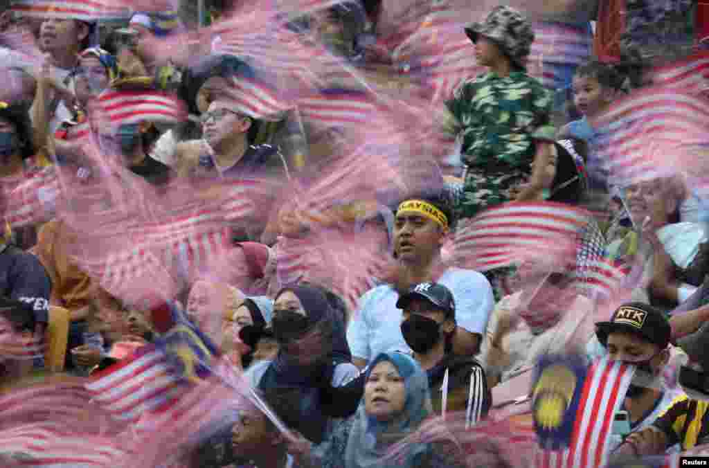 Malaysians wave their national flag during the National Day 2022 celebration at Kuala Lumpur.