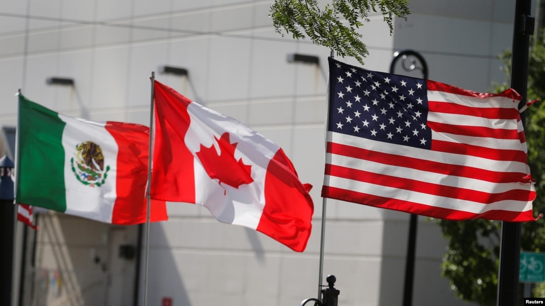 FILE - Flags of the U.S., Canada and Mexico fly next to each other in Detroit, Aug. 29, 2018. 