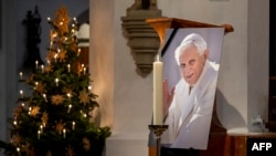 A photograph of the late former Pope Emeritus Benedict XVI is seen during a prayer in the Cathedral Church of Our Lady (Frauenkirche), Dec. 31, 2022 in Munich, Germany.