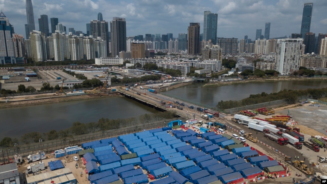 An aerial view shows a construction site for coronavirus isolation facilities and a temporary bridge linked China's Shenzhen and Hong Kong's Lok Ma Chau cities in Hong Kong, March 11, 2022.