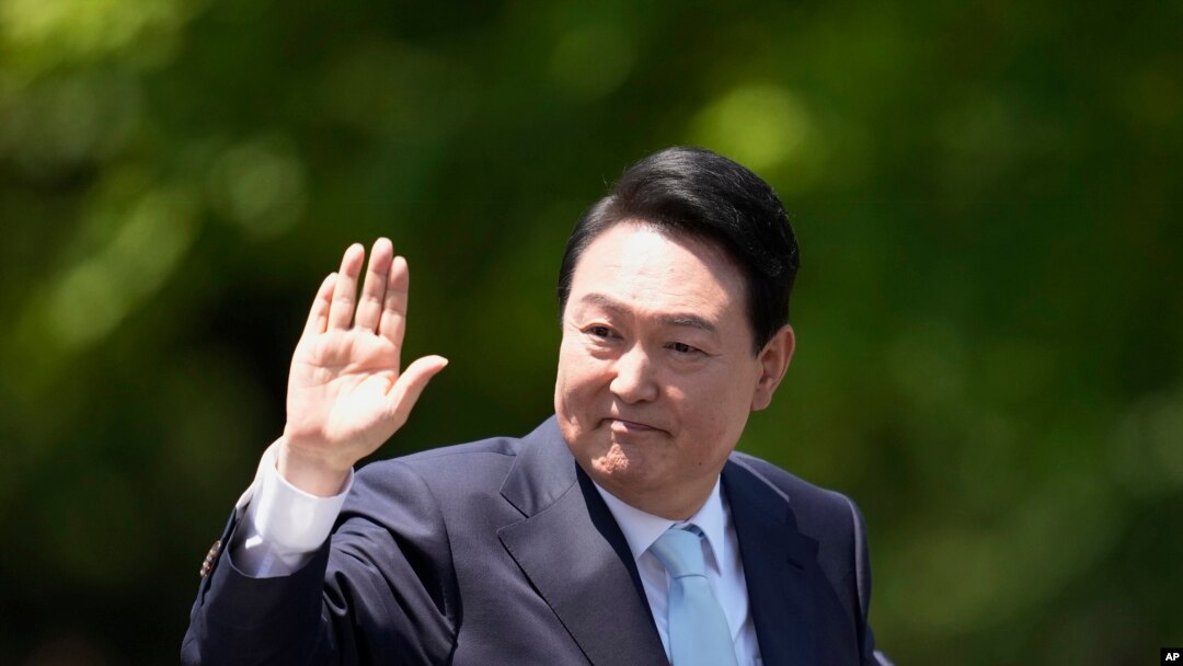 FILE -South Korea's President Yoon Suk-yeol waves from a car after his inauguration outside the National Assembly in Seoul, South Korea, May 10, 2022. 