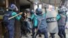 FILE - Police strike Bangladesh Nationalist Party (BNP) activists with batons as they gather in front of the party's central office in Dhaka, Bangladesh, Dec. 7, 2022.
