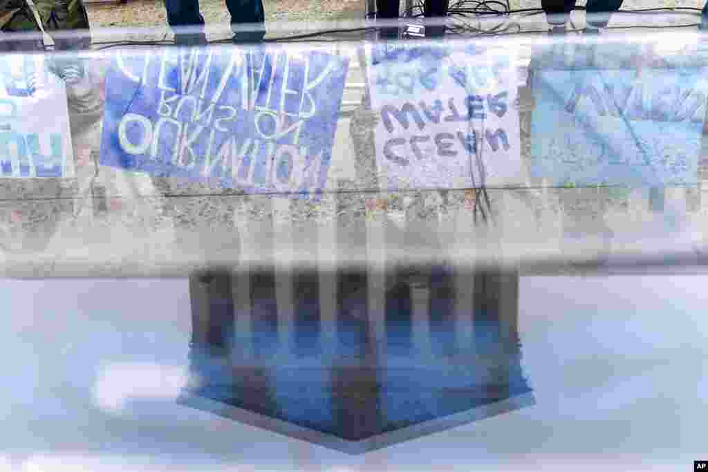 Supporters of the Clean Water Act demonstrate outside the Supreme Court in Washington, as the court begins arguments in Sackett v. Environmental Protection Agency (EPA).
