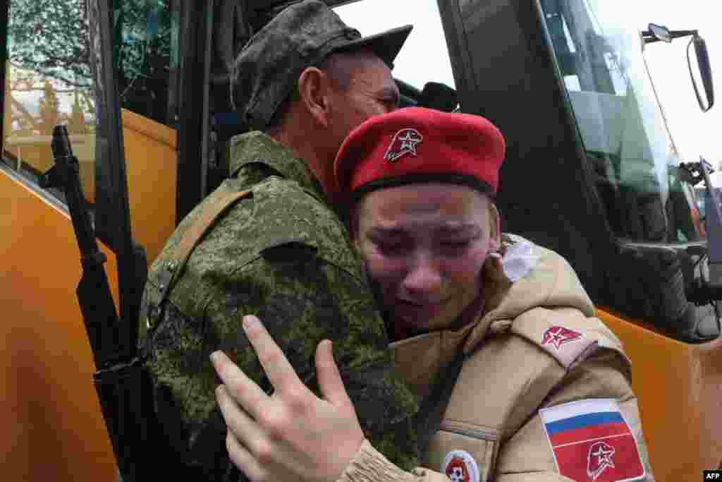 Reservists drafted during the partial mobilization attend a departure ceremony in Sevastopol, in Russian-occupied Crimea. Russian President Vladimir Putin announced on Sept. 21 a mobilization of hundreds of thousands of Russian men to bolster Moscow's army in Ukraine, sparking demonstrations and an exodus of men abroad.
