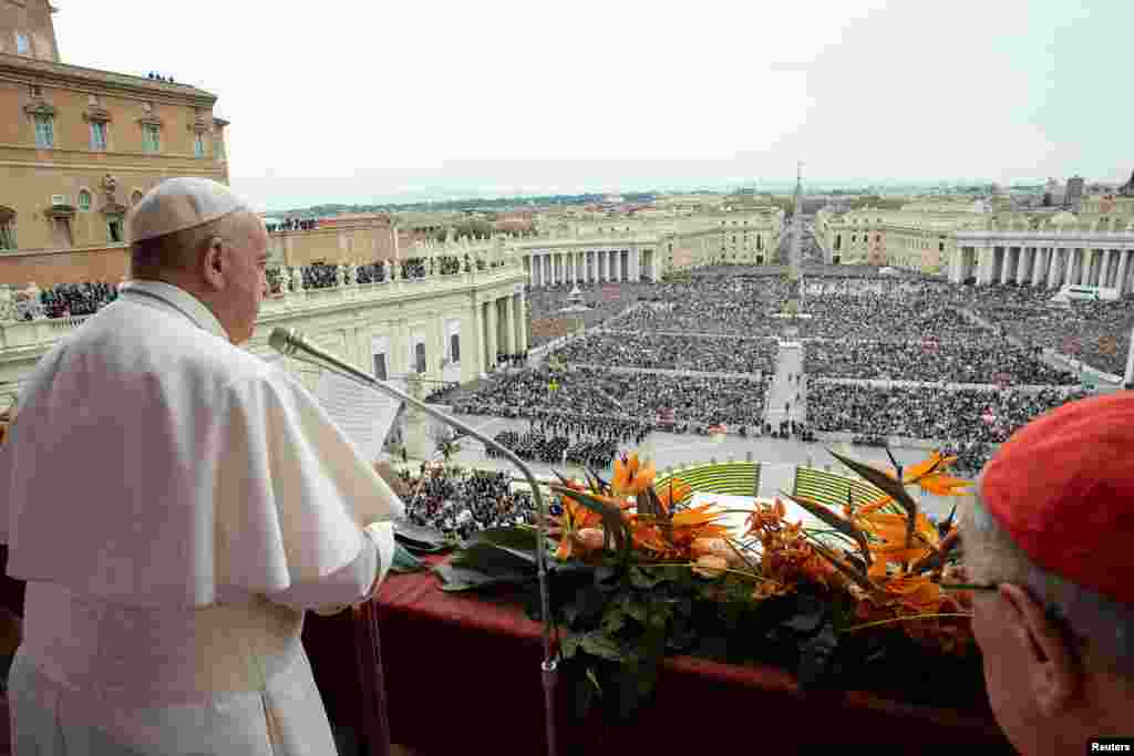 Pope Francis reads his "Urbi et Orbi" ("To the City and the World") message during Easter Mass from the balcony overlooking St. Peter's Square at the Vatican.