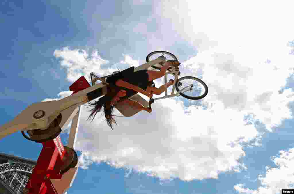 A cyclist rides the "Space Bikes" attraction on the eve of World Bicycle Day in Brussels, Belgium.