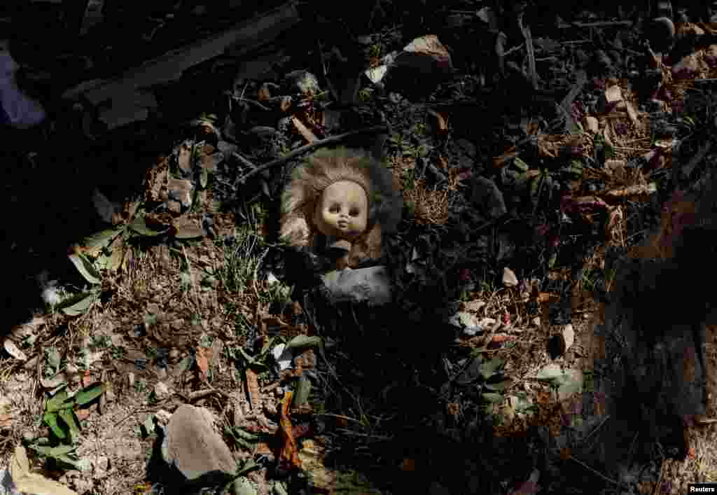 A vintage doll is pictured near a damaged kindergarten following recent Russian shelling in the city of Slovyansk, in Donetsk region, Ukraine.