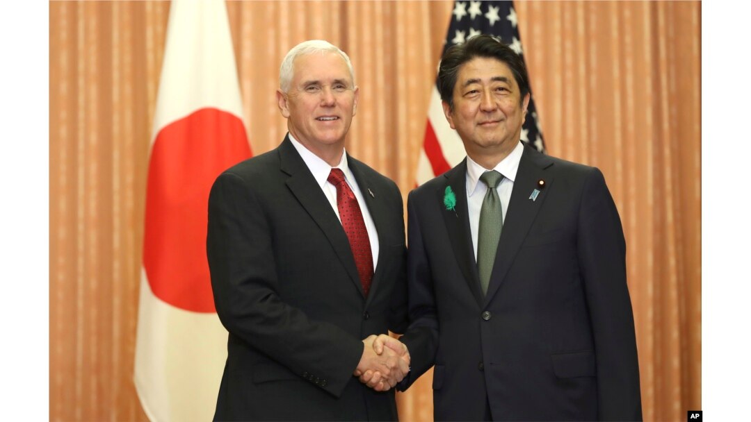 FILE - Japanese Prime Minister Shinzo Abe, right, and U.S. Vice President Mike Pence shake hands prior to a luncheon hosted by Abe at the prime minister's official residence in Tokyo, April 18, 2017.