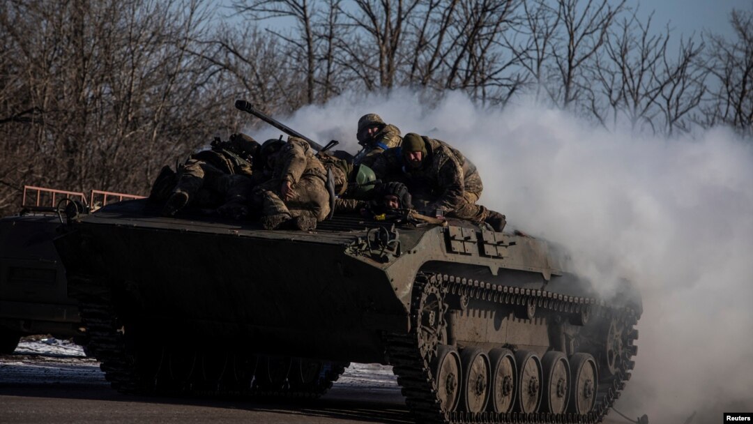Ukrainian service members ride atop of a BMP-2 infantry fighting vehicle near a frontline in Donetsk region, Ukraine, Feb. 8, 2023.