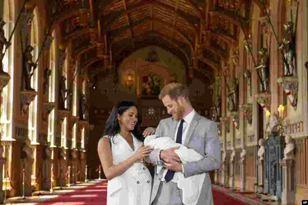 Britain's Prince Harry and Meghan, Duchess of Sussex, during a photocall with their newborn son, in St George's Hall at Windsor Castle, Windsor, south England,