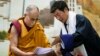 Lobsang Sangay, prime minister of the Tibetan government-in-exile, right, presents a document to spiritual leader the Dalai Lama at the Tibetan Children’s Village School in Dharmsala, India, June 5, 2014.