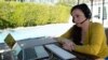 FILE - Julia Entin sits at her computer at her backyard office, coordinating efforts to rescue Holocaust survivors in Ukraine, in Los Angeles, Monday, March 14, 2022.
