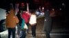 This image provided by WJLA shows migrant families as they get on to a bus to transport them from near the vice president's residence to an area church after they arrived in Washington, Dec. 24, 2022. (WJLA via AP)