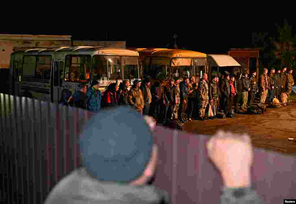 Reservists drafted during the partial mobilization line up outside a recruitment office in the Siberian town of Tara in the Omsk region, Russia.