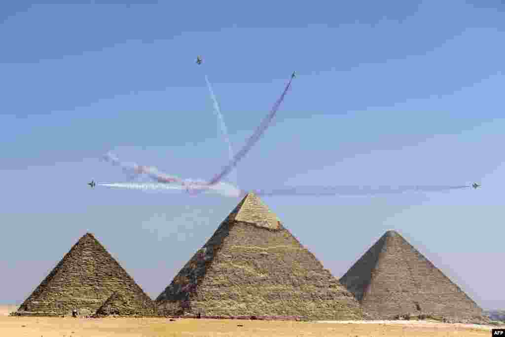 KAI T-50 Golden Eagle aircraft of the South Korean Air Force's 53rd Air Demonstration Group "Black Eagles" aerobatic team perform during the Pyramids Air Show 2022 at the Giza Pyramids Necropolis on the southwestern outskirts of the Egyptian capital.