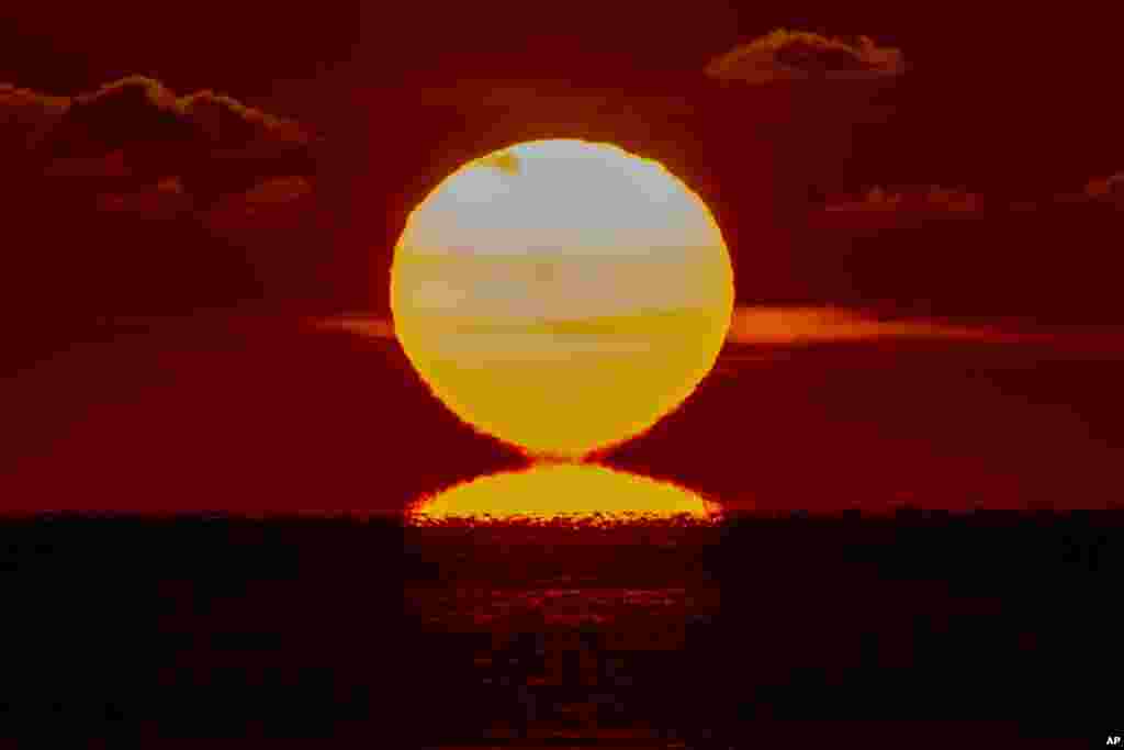 The sun rises over the Baltic Sea in Timmendorfer Strand, Germany.