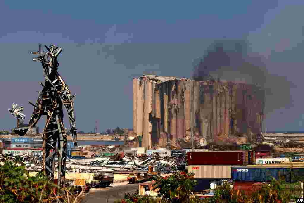 Smoke rises from Beirut's grain silos that were severely damaged in 2020 by an enormous explosion. The fire at the silos, at risk of collapse due to severe damage, ignited at the start of the month because of fermentation of remaining grain stocks, paired with rising temperatures.