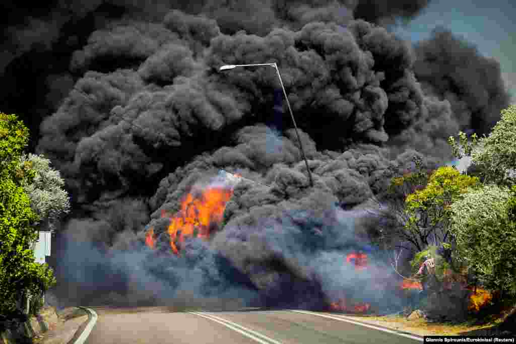 A wildfire burns at the village of Krestena, in the western Peloponnese, Greece, July 24, 2022.