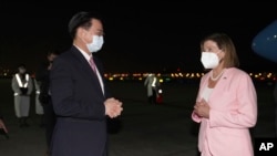 In this photo released by the Taiwan Ministry of Foreign Affairs, U.S. House Speaker Nancy Pelosi, right, is greeted by Taiwan's Foreign Minister Joseph Wu as she arrives in Taipei, Taiwan, Aug. 2, 2022. Photo via AP. 