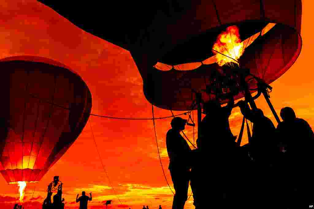 Crews inflate hot air balloons during the 39th annual New Jersey Lottery Festival of Ballooning at Solberg Airport, in Readington, N.J.