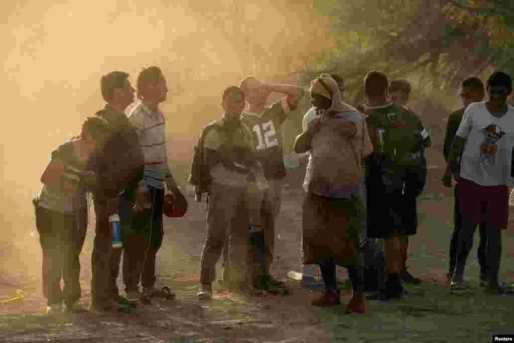 Asylum seeking migrants wait to be transported by U.S. Customs and Border Protection agents, after crossing the Rio Grande river into the U.S. from Mexico, at Eagle Pass, Texas, July 26, 2022.
