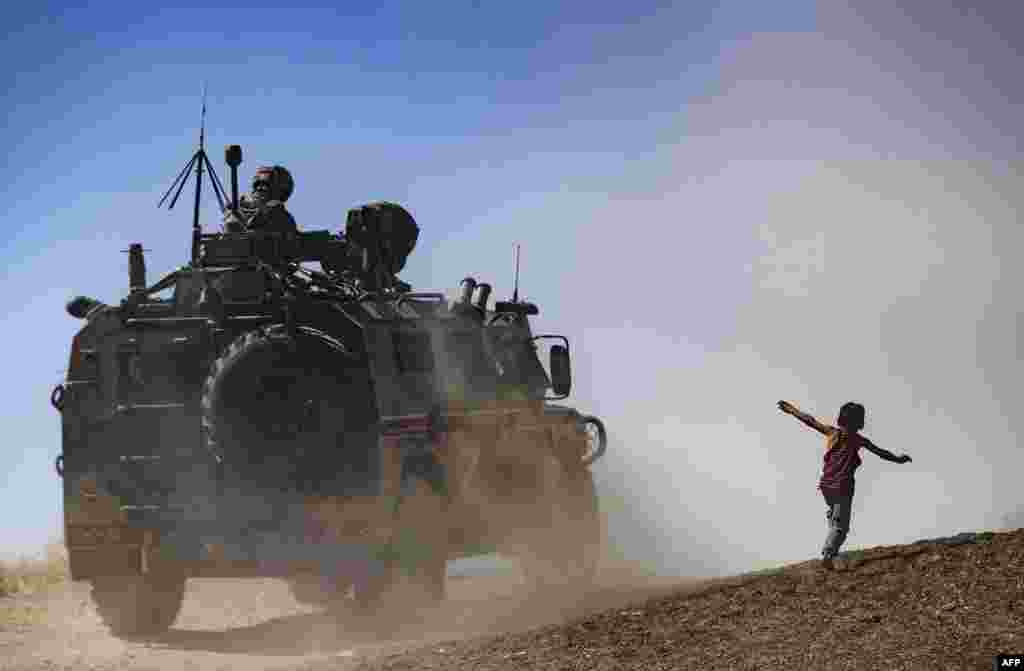 Military vehicles are pictured during a joint Russian-Turkish patrol in the eastern countryside of the town of Darbasiyah near the border with Turkey in Syria's northeastern Hasakah province.