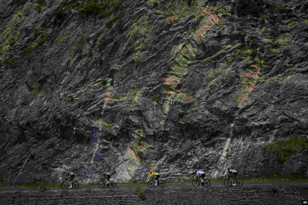 Denmark's Jonas Vingegaard, wearing the overall leader's yellow jersey, and Slovenia's Tadej Pogacar, wearing the best young rider's white jersey, speed downhill during the 18th stage of the Tour de France cycling race over 143.5 kilometers, with its start in Lourdes and finish in Hautacam, France.