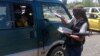 FILE - A fighter with the Islamic State distributes a copy of the Quran, Islam's holy book, to a driver in Mosul, Iraq, June 22, 2014. Islamic scholars in Bangladesh are denouncing activities of the Islamic State.