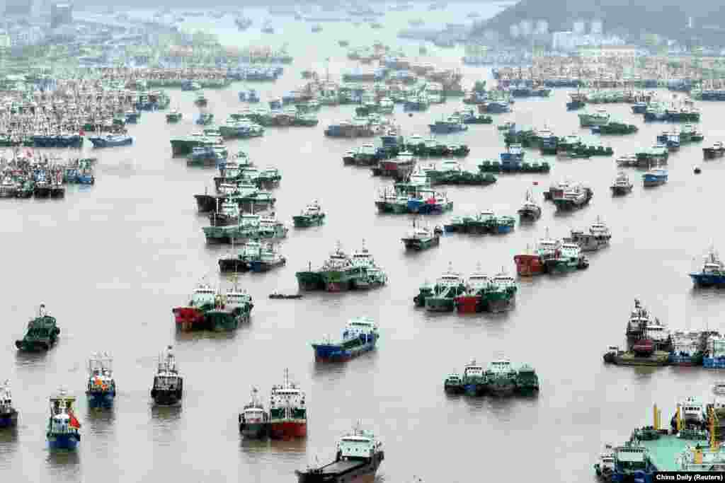 An aerial view shows vessels moored at a fishing port as Typhoon Muifa approaches, in Zhoushan, Zhejiang province, China, Sept. 13, 2022.
