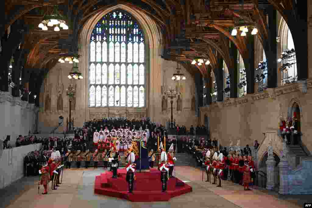 The King's Body Guards of the Honorable Corps of Gentlemen at Arms, the Life Guards, the Blues and Royals and Yeomen of the Guard, stand guard around the coffin of Queen Elizabeth II, inside Westminster Hall, at the Palace of Westminster, in London, where it will Lie in State on a Catafalque.