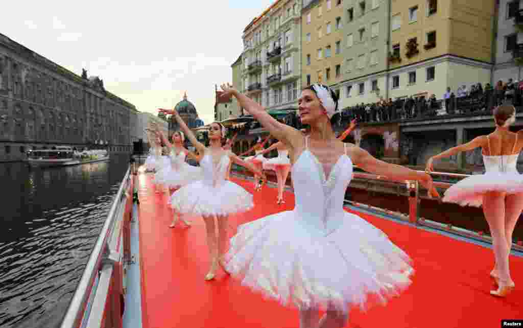 Dancers from the State Ballet Berlin (Staatsballett Berlin) ensemble perform their program "From Berlin with Love" on the deck of a ship touring Berlin's landmarks, at Spree River, German, Sept. 12, 2022.