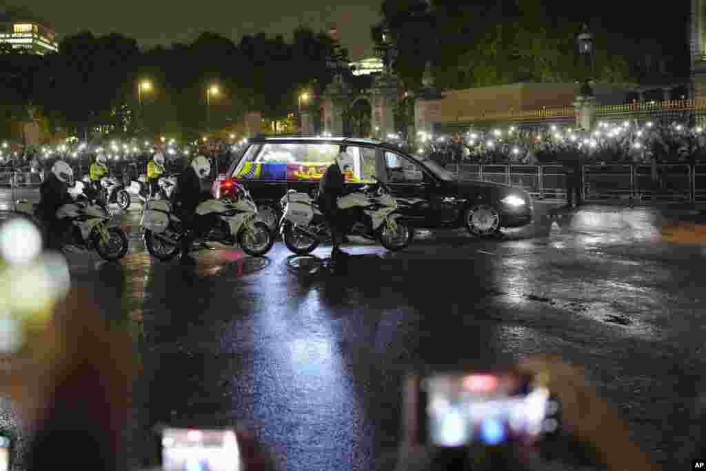 The hearse carrying Queen Elizabeth's coffin arrives at Buckingham Palace in London.