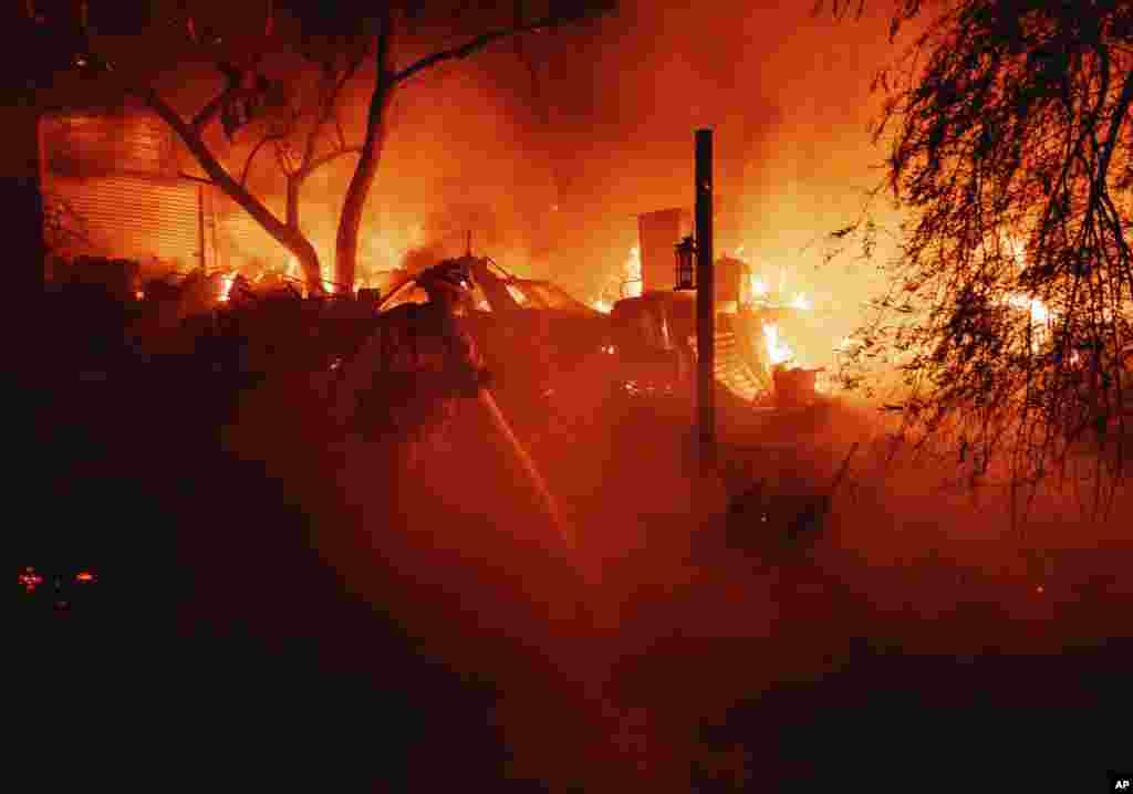 A firefighter battles the Fairview Fire, near Hemet, California, Sept. 5, 2022.