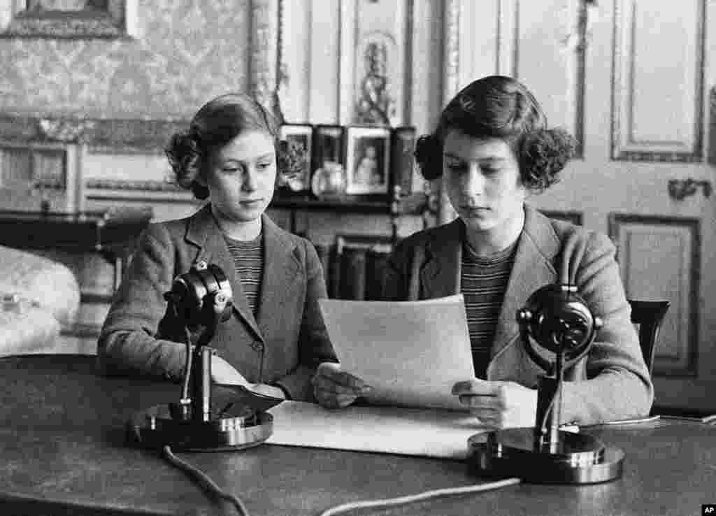 In her first radio broadcast, 14-year-old Princess Elizabeth, right, said that England's children at home were full of cheerfulness and courage. She is shown with her younger sister, Princess Margaret Rose, before the broadcast, in London on Oct. 13, 1940.