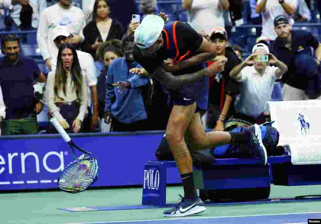 Australia's Nick Kyrgios smashes his racket after his quarterfinal match against Russia's Karen Khachanov at the U.S. Open tennis championships in New York.