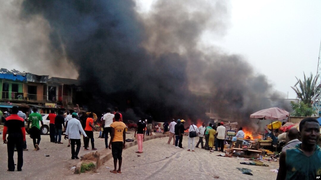 Smoke rises after a bomb blast at a bus terminal in Jos, Nigeria, May 20, 2014. 