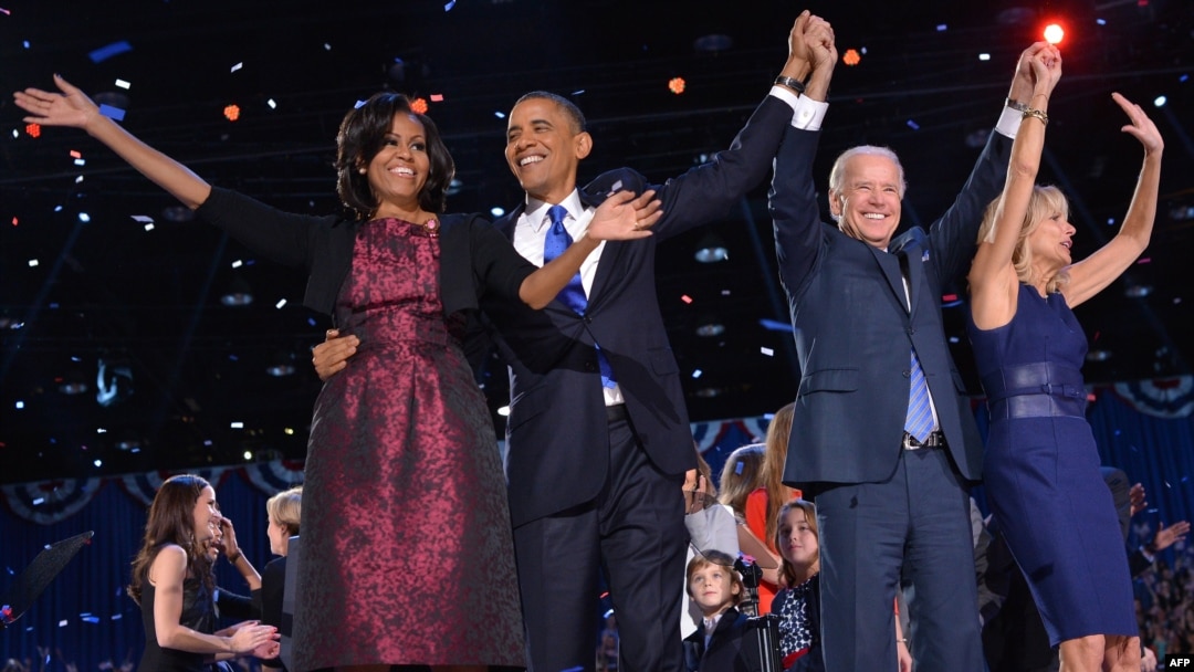 US President Barack Obama (2nd L), First Lady Michelle Obama (L), Vice-President Joe Biden and Second Lady Jill Biden wave to supporters following Obama's speech on election night November 6, 2012 in Chicago, Illinois.
