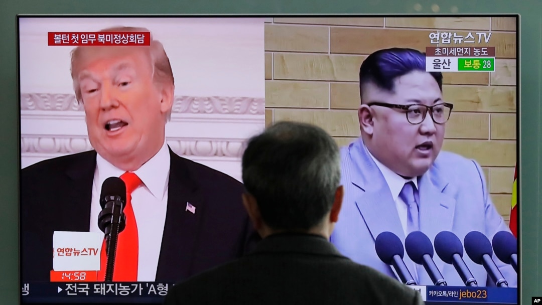 FILE - A man watches a TV screen showing file footages of U.S. President Donald Trump, left, and North Korean leader Kim Jong Un during a news program at the Seoul Railway Station in Seoul, South Korea, March 27, 2018.